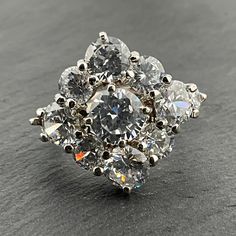 Vintage Cubic Zirconia Sterling Silver Statement Ring, UK Size P1/2, US Size 7 3/4, EU Size 56, Stamped 925, Front Width 21.4mm, Weight 8.48 Grams, Lovely Condition Dazzling Silver Multi-stone Diamond Ring, Classic Multi-stone Cluster Ring With Cubic Zirconia, Sterling Silver Multi-stone Cluster Diamond Ring, Multi-stone Cluster Diamond Ring In Sterling Silver, Sterling Silver Cluster Ring With Prong Setting, Silver Multi-stone Cluster Ring, Cluster Ring With Vs Clarity Cubic Zirconia, Multi-stone Cubic Zirconia Cluster Jewelry, Diamond White Multi-stone Cluster Ring For Anniversary