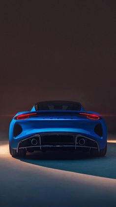 the rear end of a blue sports car