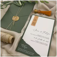 the wedding stationery is laid out next to some twine and spools