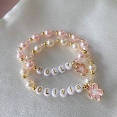 Flower Girl Bracelets personalized with her monogram initial make a pretty gift for any little girl in your bridal party.  The bracelet is made with faux pearls and alternating 18K gold-plated beads. Name Charm Bracelet, Beaded Bracelets Name, Flower Girl Bracelet, Pearl Beads Bracelet, Name Bracelet Beads, Name Bracelet Ideas, Beads With Name, Bracelets With Names, Name Bead Bracelet