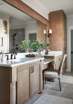 a large bathroom with two sinks and mirrors