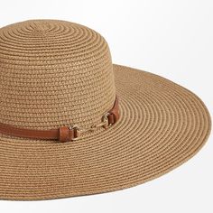 Beat the heat in style with the Women's Faux Leather Trim Wide Brim Straw Sun Hat. This chic and functional accessory is crafted from natural straw, offering breathable and lightweight protection from the sun's rays. The wide, floppy brim provides ample coverage for your face, neck, and shoulders, ensuring you stay cool and comfortable during outdoor adventures. Elevating the design is a sleek faux leather trim band that adds a touch of sophistication and a contrasting texture. Whether you're lo Chic Braided Straw Sun Hat, Chic Adjustable Braided Straw Hat, Casual Brown Straw Hat, Chic Braided Hats For Vacation, Casual Woven Brown Sun Hat, Casual Brown Woven Sun Hat, Chic Braided Beach Hats, Brown Braided Fedora Sun Hat, Spring Vacation Hats With Adjustable Strap