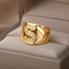 This elegant ring for any occasion features a large blocky signet design with a high-quality stainless steel construction and gold color finish. Its adjustable one-size-fits-all design makes it perfect for both men and women, and the unique A-Z choose your own letter initial allows for personalized representation. Perfect for gifting, this timeless jewelry is sure to make a statement. Harry Styles Rings, Gold Initial Ring, Wedding Initials, Letter Ring, Gold Ring Designs, Couple Jewelry, Chunky Rings, Initial Ring, Gold Initial