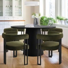 a dining room table with four chairs around it