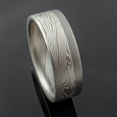 "This stunning 5mm Mokume Gane ring is shown in the Twist pattern and the Ash Palette with a low dome profile, etched finish, and added 2mm palladium rail. The Ash palette features Palladium and Sterling Silver. Pattern: Twist Palette: Ash Finish: Lightly Etched Profile: Low Dome Width: 5mm Added: 2mm palladium rail Price does NOT include stones or setting fees. We care about customer service and would like to hear from you! Please contact us to help create your treasured item, we take your conc Mokume Gane Ring, Oxidized Ring, Twist Pattern, Mokume Gane, Large Ring, Ring Sizer, Small Rings, Black Box, Size 10 Rings