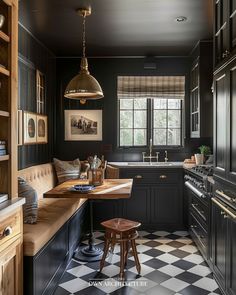 a kitchen with black cabinets and checkered flooring