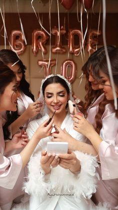 the bride is getting ready for her big day with her bridal party guests and friends