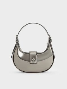 Updated for the new season, the Trice bag makes its return in a trendy metallic pewter finish -- making this the perfect party bag for nights out and festive year-end gatherings. With a clean, curved silhouette, this piece feature a belted flap detail, adorned with a distinctive triangular accent, that gives it a subtle edge. It comes with two detachable shoulder straps -- 1 short and 1 long -- offering multiple styling options. Charles And Keith Bags, Charles And Keith, Bag Stand, Size Chart For Kids, Bags Shop, Charles Keith, Party Bag, Metallic Accents, Perfect Party