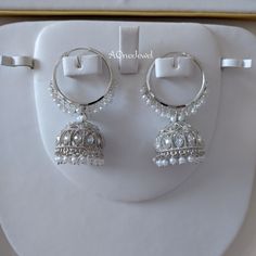 Beautiful handcrafted silver plated hoop earrings with hanging jhumki kundan, pearl finished with cz zircon will stand out in any function . Women can be worn as your daily earrings or party wear. Main Colour: Silver  Earrings Size: L x 6.5 cm / W x 3.2 cm Hallmarked Earrings As Diwali Gift, Festival Latkan Earrings For Anniversary, White Chandbali Fusion Earrings, Hallmarked Chandbali Hoop Earrings, Hand Set Round Hoop Earrings For Wedding, Silver Hoop Jewelry For Celebration, Silver Fusion Dangle Hoop Earrings, Anniversary Chandbali Danglers With Latkans, Festive White Hand Set Earrings