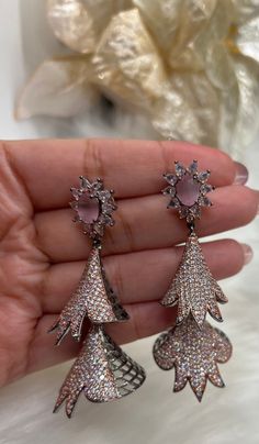 Beautiful American Diamond (AD) style Dangling Earring| Perfect for Wedding,Party wear | Indian, Pakistani,bridal jewelry.Mint ,Pink . Long Style AD Dangling Earrings. Material- American Diamond High End Quality 100% Satisfaction Guarantee: Long Lasting Plating, High-Quality Stones. Perfect for any occassion-Western, Indian and Casual day looks.    Colors Available- -Silver Pink - Silver Mint - RusticBlack Pink Care: It is advisable that you keep our products away from direct heat, humidity, and Pink Hand-set Bridal Earrings For Wedding, Pink Hand Set Bridal Earrings For Wedding, Elegant Pink Cubic Zirconia Flower Earrings, Elegant Pink Flower Earrings For Parties, Elegant Pink Teardrop Flower Earrings, Pink Teardrop Bridal Earrings For Party, Pink Hand Set Earrings For Celebration, Elegant Silver Jhumkas For Wedding, Pink Teardrop Flower Earrings For Wedding