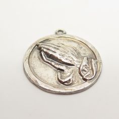 Has an engraving, but can be removed by a local jeweler. 925 Sterling Silver Vintage Hands in Prayer Charm Pendant Weight: 5.5g WELCOME TO PAWN SHOP We are an actual pawn shop and have been in business for over 25 years. Since 1990, our establishment has been serving a variety of clients by providing them with short term cash solutions and options of liquidity regarding their treasured heirlooms. Acknowledging that today′s customers are very sophisticated and are looking for a variety of investm Engraved White Gold Jewelry For Commemoration, Collectible Nickel Free White Gold Jewelry, Symbolic Silver Jewelry For Memorials, Sterling Silver Coin Charms Jewelry, White Gold Jewelry Stamped 925 For Commemoration, Symbolic Silver Jewelry For Memorial, Commemorative Silver Jewelry With Charms, Stamped 925 Medallion Jewelry For Memorial, Antique Silver Charms Sterling Silver Jewelry