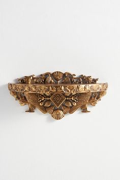 an ornately decorated gold bracelet on a white background