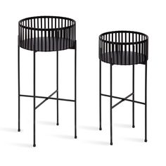 two black metal side tables with round tops and circular legs, one in the shape of a basket