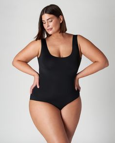 This bodysuit is a dream come true! Its perfect for all body types, won't dig into your skin, and keeps you dry. Plus it has patented technology that helps protect against everyday leaks-periods, urine or sweat. It absorbs up to 9ml of liquid so it's perfect for daily use or light days during your period. And the black lined gusset provides superior stain protection in every colourway - what more could you ask for?! A sleeveless plus size top to transform your workwear and everyday outfits Viita Black Second-skin Bodysuit With Built-in Bra, Black Second-skin Leotard With Scoop Neck, Black Scoop Neck Second-skin Leotard, Compressive Smoothing Bodysuit With Scoop Neck, Compressive Smoothing Scoop Neck Bodysuit, Sleek Black Bodysuit With Smoothing Detail, Black Seamless Full Coverage Bodysuit, Black Second-skin Full Coverage Swimwear, Black Tight-fitting Sleek Bodysuit