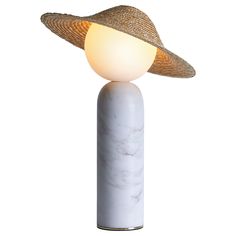 a white table lamp with a hat on it's top and a marble base