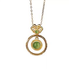 Material: S925 Sterling Silver with Gold PlatingGemstone: Jade, approximately 5mm (large), 2mm (small)Weight: Approximately 1.5gSize: Pendant Length: 22mm, Width: 15mm Description:Embrace timeless elegance with this Jade Double Circle Pendant Necklace. The design features a larger jade gemstone encased in a delicately twisted gold-plated S925 sterling silver frame, complemented by a smaller jade accent at the top. The double-circle structure offers a unique aesthetic that merges modern minimalism with traditional charm. This lightweight necklace is perfect for everyday wear, adding a refined touch to any outfit. The green jade's natural luster provides a subtle yet captivating appeal, making this piece an essential addition to your jewelry collection. Note: As jade is a natural gemstone, s Elegant Jade Necklaces As Gifts, Elegant Jade Necklaces For Gifts, Elegant Jade Necklace For Gifting, Elegant Jade Necklace As Gift, Jade Clavicle Chain With Round Pendant, Elegant Jade Necklace For Formal Occasions, Elegant Jade Gemstone Necklaces, Elegant Jade Necklace With Gemstone, Elegant Jade Necklace Round Shape