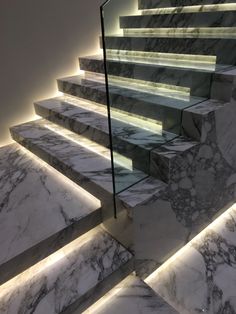 marble stairs with illuminated steps leading up to them