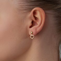 14k gold mini heart dangle earrings are a dainty and elegant way to add a touch of sparkle to your look. The tiny hearts are made of solid gold and giving them a subtle yet sophisticated look. They are lightweight and comfortable to wear, making them perfect for everyday wear. Whether you're dressing up for a night out or just running errands, these earrings will add a touch of luxury to your outfit. Tiny Heart Earrings are also a thoughtful and meaningful gift for a loved one. The heart shape i Cheap Minimalist Gold Heart Earrings, Heart Shape Earrings Gold, Minimalist Dangle Heart Earrings, Minimalist Gold Heart Earrings With Charm, Dainty Dangle Heart Earrings For Everyday, Minimalist Gold Heart Drop Earrings, Minimalist Yellow Gold Heart Drop Earrings, Dainty Heart Charm Earrings For Everyday, Chic Yellow Gold Heart Charm Dangle Earrings