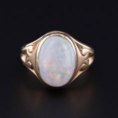 This antique ring (circa 1900) features a white opal set in 14k gold. The face of the ring measures 0.6 inches by 0.45 inches wide and is in good condition with some crazing to the opal.  The ring is a size 5.5, but it can be resized free of charge. We have many other fantastic offerings of period fine and costume jewelry posted on our Etsy store, so please consider browsing our other items. We send all items in individually packaged gift boxes. + Trademark Antiques Shop Homepage https://www.ets Classic Cabochon Opal Ring, Classic Cabochon Opal Ring For Formal Occasions, Classic Yellow Gold Opal Ring, Classic Opal Ring Collectible, Heirloom Opal Ring In 14k Gold, Classic Oval Opal Ring Collectible, Victorian 14k Gold Opal Ring For Anniversary, Victorian Style Hallmarked Opal Ring In Yellow Gold, Victorian Opal Ring In 14k Gold For Formal Occasions