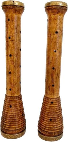 two wooden candlesticks sitting next to each other