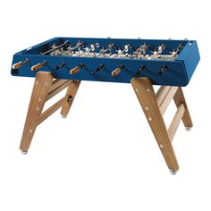 a foosball table with wooden legs and small toy figurines on it