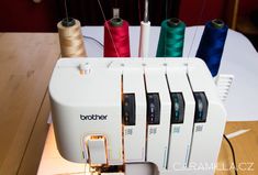 a sewing machine with four spools of thread on it