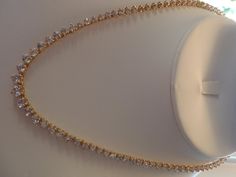 "ALL HANDMADE 14K SOLID YELLOW GOLD NECKLACE WITH 105 GRADUATED ALL NATURAL, MINED WHITE SAPPHIRES - NOT LAB CREATED. GUARANTEED. RECENTLY APPRAISED BY A GIA GRAD GEMOLOGIST. ABSOLUTELY STUNNING, WORN ONLY A HANDFUL OF TIMES. I AM THE SOLE OWNER. IT HAS A SECURE TONGUE CLASP CLOSURE & WRAP-AROUND CATCH THAT SNAPS SHUT TIGHTLY FOR ADDITIONAL SECURITY. Approximately 57 carats total of sapphires. Largest stone approx. 6 mm and smallest approx. 2.5mm. VS clarity. Total gram weight for the neckla Formal 14k Yellow Gold Tennis Necklace, Gold Cubic Zirconia Bridal Necklace With Diamond Cut, Gold Tennis Necklace With Diamond Accents As A Gift, Gold Round Tennis Necklace For Gift, Gold Bridal Necklace For Anniversary Fine Jewelry, Gold Single Strand Necklace For Formal Occasions, Luxury Gold Bridal Necklace For Anniversary, Formal Gold Single Strand Necklace, Gold Tennis Necklace With Prong Setting As Gift