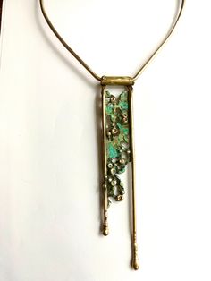 This Art Deco style bronze necklace with a nice green/blue patina is great on its on or layered!  approximately 6" long on the chest  Lays approximately 15" around the neck **all necklaces are handmade with no molds or anything so each one will have the slightest variations in erosion and color!