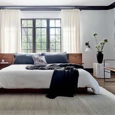 a bedroom with white walls and black accents