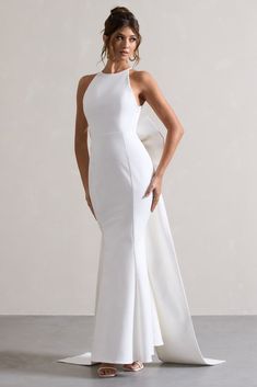 Bestow | White Open-Back Maxi Dress With Oversized White Bow Fitted White Backless Dress For Prom, White Backless Gown With Sweep Train, White Backless Dress With Back Zipper, White Backless Prom Gown, White Backless Gown For Prom, Chic White Backless Dress With Back Zipper, Fitted White Backless Dress With Back Opening, White Halter Neck Dress With Back Opening, White Prom Dress With Back Zipper