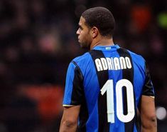 a close up of a soccer player wearing a blue and black uniform with the number 10 on it