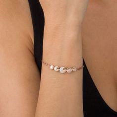 Set a whimsical tone with this romantic fashion bracelet. Crafted in sterling silver with 14K rose gold plate, this serene design showcases five graduated-size sculpted circles - each sparkling with petite shimmering white sapphires in crescent- and half-moon-shaped frames representing the lunar phases. Buffed to a brilliant luster, this 7.5-inch double-strand rope chain bracelet secures with a lobster claw clasp. Rose Gold Charm Bracelet With Jubilee Detail, Rose Gold Charm Bracelet With Jubilee Bracelet, Rose Gold Jubilee Charm Bracelet, Adjustable Rose Gold Chain Bracelet Fine Jewelry, Adjustable Rose Gold Chain Bracelet, Adjustable Rose Gold Diamond Bracelet, Rose Gold Sterling Silver Jubilee Bracelet, Adjustable Rose Gold Sterling Silver Chain Bracelet, Adjustable Sterling Silver Chain Bracelet In Rose Gold