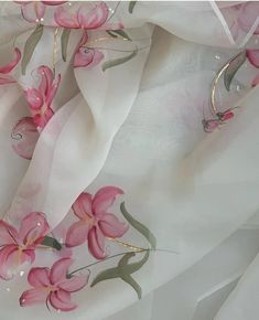 pink flowers are painted on white fabric with gold trim around the edges and bottom edge