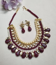 Ruby Red Kundan Necklace Set With Earrings, Indian Jewelry, Bollywood Jewelry Set, Sabyasachi Inspired Jewelry, Multi Layered Necklace * Necklace Length: 17 inches (comes with adjustable sarafa/dori/cord) * Earrings Length: 1 inch approx * Material: Brass, Kundan * Package: Necklace and Earrings STYLE TIP: The Look Is Stunning And Perfectly Suitable For All Kinds Of Dressy Occasions. Wear with an ethnic outfit for any occasion. This traditional set can complement any International attire. ABOUT Red Kundan Jewelry With Round Beads, Red Necklaces With Latkans For Diwali, Elegant Red Necklace With Latkans, Red Kundan Necklace With Latkans For Party, Heavy Red Jewelry For Puja, Red Meenakari Jewelry With Round Beads, Red Meenakari Round Beaded Jewelry, Red Latkans Necklace For Party, Red Beaded Kundan Jewelry