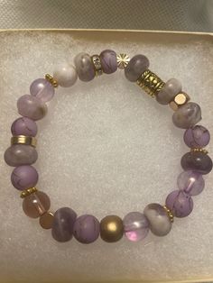 "Gorgeous stretch bead bracelet -Gold detailing, glass and stone beads in shades of purple -Neutral plums, lavender, creams and tan -Matte and shiny gold details -Stretch bracelet so easy to slip on and go! 6.75-7.0\" stretch fit.  -Fits most wrists. -One of a kind! Perfect to stack! See my other listings of bracelets and create a custom stack of your own!  https://www.etsy.com/shop/LivWithGraceStyles" Adjustable Gold Stretch Bracelet With Colorful Beads, Bohemian Style Gold Stretch Bracelet With Round Beads, Adjustable Stackable Rondelle Stretch Bracelet, Adjustable Stretch Bracelet With Gold Round Beads, Casual Hand-strung Stretch Bracelet, Trendy Adjustable Stretch Bracelet With Gold Beads, Faceted Beads Stretch Bracelet, Casual Gold Jewelry With Faceted Beads, Adjustable Crystal Bracelet With Gold Beads