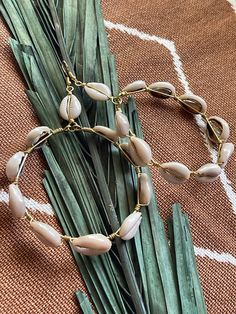 Elevate your beach vibes with our handcrafted cowrie shell hoop earrings. Each pair is meticulously crafted to exude bohemian charm and cultural elegance. These stunning earrings feature genuine cowrie shells delicately wire wrapped, creating a timeless accessory perfect for any occasion. Embrace your divine feminine energy with these versatile earrings, whether you're lounging by the shore or exploring the city streets. Add a touch of natural beauty to your look with these artisanal cowrie shel Nickel-free Bohemian Earrings For Vacation, Bohemian Nickel Free Earrings For Vacation, Bohemian Nickel-free Earrings For Vacation, Bohemian Earrings With Ear Wire For Vacation, Nickel-free Bohemian Earrings For Beach, Bohemian Nickel-free Earrings For Beach, Bohemian Nickel-free Hoop Earrings For Beach, Bohemian Ear Wire Jewelry For Beach, Bohemian Ear Wire Jewelry For The Beach