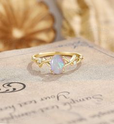 Twisted Opal Engagement Ring, Oval Cut Opal Ring Yellow Gold, Vine Opal Ring, Vintage Twig Ring Ring#:NC1048 Center stone: Opal oval cut 5*7mm Side stones: moissanite Shape: Round cut Size/weight:1.3mm Custom orders are most welcome! Please feel free to ask for any item, any adjustments or anything else you want me to make. Rush order Orders can be expedited for a fee. If your order needs to be expedited, please contact us ASAP. Layaway plan We offer layaway plan that works with a $100 as the fi Simple Opal Engagement Ring, Heirloom Oval Opal Ring For Anniversary, Gold Opal Ring With Halo Design - Gift, Oval Opal Promise Ring, Gold Oval Opal Ring Fine Jewelry, Gold Oval Crystal Promise Ring, Oval Solitaire Ring For Marriage, Heirloom Oval Crystal Ring For Anniversary, Yellow Gold Oval Solitaire Opal Ring