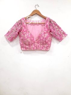 This Made to Order/Made to Measurement/Custom Made Indian Ethnic Blouse. - Fabric - Embroidered Net - Color  pink - Princess Cut - Rich Lined - Shoulder string with latkans - Sleeveless - Extra margin and extra stitches included in the blouse - It can be customize in any color, design or size  MEAUREMENTS & CUSTOMIZATIONS This blouse can be purchased in your standard sizing and pattern. Please choose your Chest Size (measured in inches) from the drop-down box.. For custom sizing please include the below measurements in the the notes to whenever you placed the order. * Chest size: * Waist size: * Blouse Length: * Bicep: * Arm-hole: * Sleeve Length: * Front Neck Depth: * Back-Neck Depth:  Sleaves Around PLEASE NOTE: BUYERS ARE RESPONSIBLE FOR ANY CUSTOMS AND IMPORT TAXES THAT MAY APPLY. This V-neck Sequin Wedding Set, V-neck Wedding Sets With Sequins, Festive V-neck Sequin Sets, V-neck Traditional Wear With Resham Embroidery For Party, Anarkali Lehenga With V-neck Fitted Style, V-neck Traditional Wear For Navratri Party, Festive Party Wear Choli With Floral Embroidery, Embroidered Fitted V-neck Choli, Festive Floral Embroidered Party Wear Choli