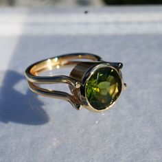 14K solid yellow gold ring by ICCHA with 10mm round peridot.  Size 5.75. Formal Rings With Polished Peridot, Formal Peridot Rings With Polished Finish, Yellow Gold Peridot Round Rings, Gold Peridot Birthstone Ring, Round Peridot Jewelry With Polished Finish, Yellow Gold Peridot Solitaire Birthstone Ring, Green Birthstone Ring In 14k Gold, Round Peridot Birthstone Ring With Bezel Setting, Peridot Birthstone Ring With Bezel Setting