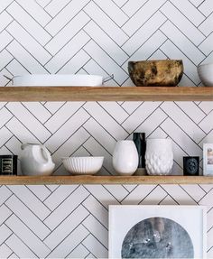 a shelf with some vases and bowls on it