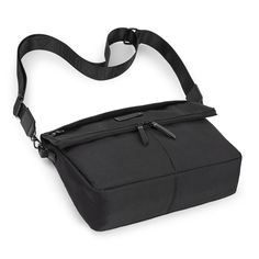 an empty black bag is shown on a white background, with the strap down to it's side