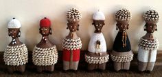 african dolls are lined up against a wall