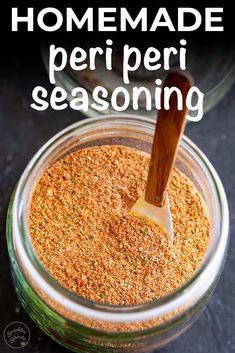 homemade peri peri seasoning in a glass jar with a wooden spoon