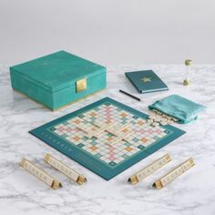 a board game set up on top of a marble table with other items around it