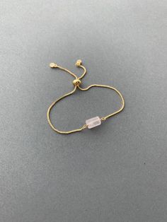 "This bracelet is a must have for your wardrobe! A rough cut gemstone bead is wire wrapped to a comfortable adjustable bracelet chain. It comes in your choice of sparkly gold, silver, or rose gold finish. It comes packaged with care in a beautiful gift box. *For more bracelets: https://www.etsy.com/shop/saraweberjewelry/?section_id=7769955 M A T E R I A L S * & * S I Z E * Natural Stone * Chain - Rose gold plated, gold plated, or rhodium plated * Length - Adjustable 5.5\" - 9\" P R O D U C T Gold Rose Quartz Bracelets For Jewelry Making, Adjustable Gold Crystal Bracelet With Gemstone, Adjustable Gold Crystal Gemstone Bracelet, Elegant Rose Quartz Crystal Bracelet For Gift, Elegant Rose Quartz Crystal Bracelet Gift, Elegant Pink Resizable Beaded Bracelets, Delicate Adjustable Crystal Bracelet With Gemstone, Adjustable Gold Rose Quartz Jewelry, Delicate Adjustable Crystal Gemstone Bracelet