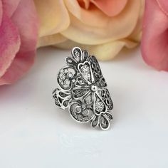 "Elevate your style with our stunning Sterling Silver Filigree Art Lace Embroidery Long Statement Ring. This intricate and elegant ring features delicate filigree work in a beautiful lace-like pattern, making it a perfect addition to any outfit. Made from high-quality sterling silver, this ring is both durable and stylish. Its long and bold design adds a touch of glamour to any occasion, making it perfect for both formal and casual wear. Shop now and make a statement with our Sterling Silver Filigree Art Lace Embroidery Long Statement Ring! Ring Length: 1.15\" and Width: 0.60\"  This metal embroidery filigree ring is oxidized and highly polished.  Comes with a velvet pouch, silver polish cloth and a luxurious gift box. Filigree is made of delicate metal strands that have been skillfully fa Traditional Filigree Ring For Anniversary, Bohemian Sterling Silver Butterfly Ring, Ornate Sterling Silver Filigree Ring, Bohemian Filigree Open Ring With Intricate Design, Silver Filigree Open Ring, Bohemian Flower Ring With Intricate Design For Gift, Sterling Silver Filigree Ring With Oxidized Finish For Wedding, Bohemian Open Filigree Ring With Intricate Design, Bohemian Flower Ring With Intricate Design