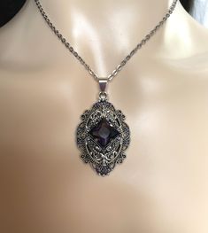 "This richly detailed antiqued silver plated filigree pendant, is adorned with dazzling VIOLET PURPLE glass rhinestones that perfectly accentuate a larger jewel in the center. Pendant measures 2 1/4\" tall (including the bail) and 1 1/4\" wide. It is worn on a cable chain in your choice of length and fastens with a lobster clasp. Listing is for necklace ONLY. Matching earrings are listed in our store. This is available in a variety of stone colors in our store, along with matching earrings. If y Silver Jewelry With Intricate Design For Vintage Events, Victorian Filigree Necklace For Party, Antique Silver Victorian Jewelry For Wedding, Silver Filigree Jewelry For Vintage Events, Antique Finish Pendant Jewelry For Wedding, Engraved Silver Jewelry For Vintage Events, Victorian Formal Jewelry With Oxidized Finish, Vintage Charm Silver Jewelry For Vintage Events, Elegant Antique Silver Jewelry With Vintage Charm