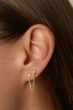 A woman wearing a double stud chain earring. Cheap Small Hoop Piercings For Pierced Ears, Double Ear Piercing Top, Earrings 2 Holes Stud, Earrings 2 Holes Hoops, Cheap Trendy Single Earring Piercing, Cheap White Internally Threaded Piercings, Cheap Everyday Pierced Earrings, Trendy Affordable Piercings As Gift, Cheap Modern Everyday Cartilage Earrings