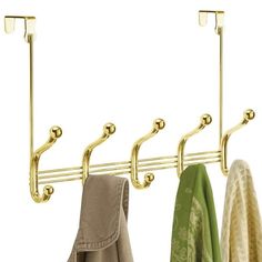 three coats hanging from hooks on a coat rack