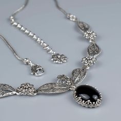 Introducing our stunning Filigree Art Black Onyx Gemstone Women's Silver Princess Model Necklace! Measuring 14 or 17 inches in length with a 2-inch extension, this necklace is designed to fit comfortably on any neck. The centerpiece of this necklace is the beautiful cabochon oval cut black onyx gemstone that exudes timeless elegance and sophistication. The intricate filigree art design adds a touch of intricacy to the necklace's aesthetic appeal, creating a beautiful piece of jewelry. Our neckla Boho Pendant Necklace, Floral Pendant Necklace, Princess Necklace, Filigree Necklaces, Filigree Jewelry, Stylish Necklace, Boho Pendant, Onyx Gemstone, Rose Quartz Gemstone